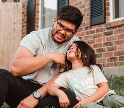 dad and daughter smiling together