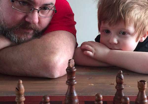 dad and son playing chess