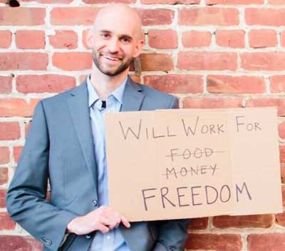 man holding up a sign, "will work for freedom"