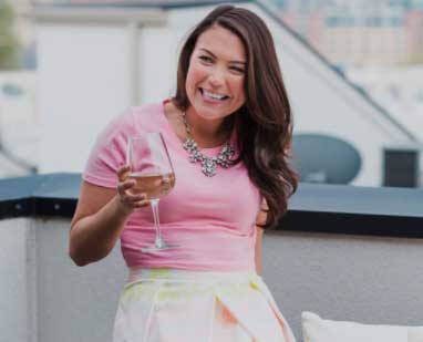 woman sitting down with a glass of white wine